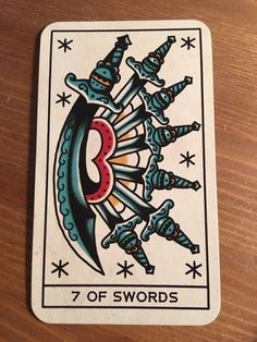 the seven of swords playing card on a table