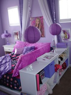 a bedroom decorated in purple and white