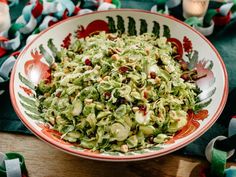 a bowl filled with shaved brussels sprouts and cranberries