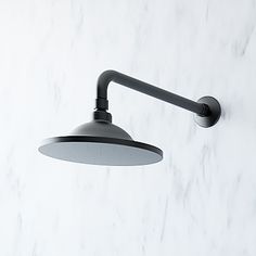 a black and white wall light on a marble background with the shade off it's head