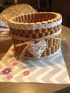 a basket made out of wine corks on top of a table next to a bottle of wine