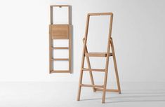 a wooden ladder leaning against a wall next to a shelf with a mirror on it