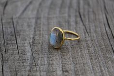 ♦♦ Beautiful handcrafted ring ◘Stone Information: Genuine Labradorite - Color: Purple Cut: Oval Cabochon Size: 13X18 mm ◘ Metal: 925 Sterling Silver ◘ Band: 1.5 mm ◘ Setting: Open back bezel setting ◘ Finish: High polish (shiny) ◘ Nickel free ◘ Handmade band: 14 gauge solid sterling wire This ring is adorably rustic, easy to wear, & stackable! ◘Please Note - The Ring in the Picture can be available or Sold out. Every Ring is Made of a Unique Gemstone. Therefore, Colors and Inclusions of the Round Untreated Jewelry As A Gift, Handmade Gold Moonstone Ring In Sterling Silver, Handmade Yellow Gold Moonstone Ring In Sterling Silver, Gold Sterling Silver Rings With Large Stone, Oval Labradorite Promise Rings, Minimalist Round Jewelry With Large Stone, Handmade Minimalist Opal Ring For Anniversary, Minimalist Natural Stone Ring For Anniversary, Minimalist Handmade Opal Ring For Anniversary