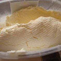 a plastic container filled with ice cream on top of a table