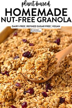 a wooden spoon filled with granola on top of a table