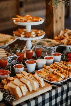 a table topped with lots of food and dipping sauces