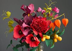 a vase filled with colorful flowers on top of a table