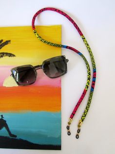 Sunglasses chain - Boho eyewear strap - Choose from 3 colors - Wax fabric glasses holder - Beaded glasses strap. Practical fun and colorful eyeglass accessories to keep your eyeglasses hanging safely. - great idea for gifting - 3 color choice. Choose your color in the drop-down menu. - Easy rubber attachments - Lightweight wax cotton fabric - handsewn, handmade by me. Trendy Adjustable Sunglasses For Travel, Trendy Adjustable Glasses Chains For Festivals, Trendy Adjustable Glasses Chains, Trendy Multicolor Glasses Chains, Casual Adjustable Sunglasses For Festivals, Multicolor Adjustable Chain Glasses Chains For Fashion, Adjustable Glass Sunglasses As Gift, Trendy Adjustable Glasses Chains As Fashion Accessory, Adjustable Black Glasses Chains Fashion Accessory