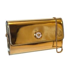 Elevate your evening ensemble with this Versace La Medusa crossbody clutch bag. The reflective gold patent leather complements the iconic La Medusa logo plaque, embedded with white crystals for a luxurious finish. The bag securely fastens with a snap button closure, revealing a chic black fabric interior equipped with 10 card slots and a central zip compartment for effortless organization. Carry it as a sophisticated clutch or utilize the elegant gold chain shoulder strap for versatile styling. Evening Clutch Bag With Logo Plaque, Classic Gold Bags With Logo Plaque, Evening Clutch Bags With Logo Plaque, Gold Evening Bag With Logo Plaque, Gold Bag With Metal Logo For Formal Occasions, Classic Gold Clutch For Events, Designer Gold Bag With Logo Plaque, Designer Gold Evening Bag With Chain Strap, Gold Bags With Metal Logo For Formal Occasions