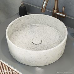 a white sink sitting on top of a bathroom counter next to a faucet