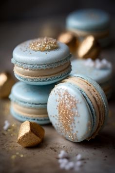 three macaroons with gold sprinkles on them