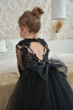 CHRISTMAS IS COMING ☃️ 🌲-25% ON ALL ASSORTMENT An incredible black dress for a flower girl!  Crafted from shimmering gold lace, with flared sleeves and a gorgeous open back🌸  This dress will make your little girl a real princess⭐️💫 Answers to the most popular questions: - All our dresses are handmade, so the dresses will be exactly as in the photo. We guarantee incredibly high quality. - We do not make dresses to order or with changes, dresses can only be as in the photo, and in standard sizes. - All dresses have detachable trains, so if you need the dress to be without a train at the ceremony, you can easily remove it. - The production time of the dress is 1-2 days. - Delivery 2-4 days. - All goods are shipped from our warehouse in the USA, Minnesota. If you have any questions - write Black And White Flower Girl Dress, Flower Girl Dress Pattern, Black Wedding Flowers, Gothic Wedding Theme, Black Flower Girl Dress, Ivory Girls Dress, Black Flower Dress, Princess Tutu Dress