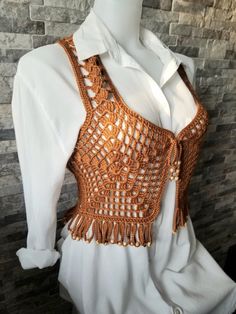 a mannequin wearing a white shirt and orange crochet