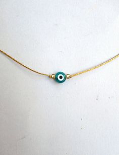 Evil eye choker necklace, String choker, Minimalist The evil eye is used to protect the person that wears it from the malevolent look of others who envy or dislike that person. The necklace is made with 1mm silver/gold waxed string,and has a 8mm emerald glass evil eye bead. At the end it is adorned with seed beads. Total length: 80cm / 31 inches It is adjustable to fit a lot of sizes. Custom orders for different colour combinations are welcome. Other necklaces in my shop: https://www.etsy.com/sh Adjustable Delicate Chain Choker As Gift, Evil Eye Choker Necklace As Gift, Evil Eye Choker Necklace For Gift, Adjustable Dainty Evil Eye Jewelry, Handmade Adjustable Eye-shaped Jewelry, Minimalist Handmade Choker As A Gift, Minimalist Handmade Choker As Gift, Adjustable Evil Eye Choker Necklace, Adjustable Evil Eye Choker Jewelry