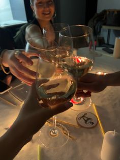 three people are toasting with wine glasses