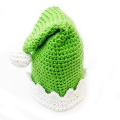 a crocheted green hat with white trim