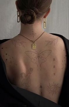 the back of a woman's body with tattoos on her upper and lower back