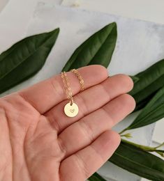 "Dainty gold heart necklace. Created and finished by hand in either 14k gold fill or sterling silver. Charm measures 3/8\". To Purchase simply select the material and chain you would like from the drop down menu then click \"Add to cart\"." Dainty Hand Stamped 14k Gold Charm Necklaces, Tiny Minimalist Charm Necklace For Anniversary, Minimalist Heart Charm Jewelry For Anniversary, Minimalist Heart Charm Jewelry For Anniversary Gift, Minimalist Tiny Charm Necklaces For Anniversary, Minimalist Tiny Charm Necklace For Anniversary, Dainty Hand Stamped 14k Gold Necklace, Minimalist Yellow Gold Hand Stamped Charm Necklace, Minimalist Hypoallergenic Heart Pendant Jewelry