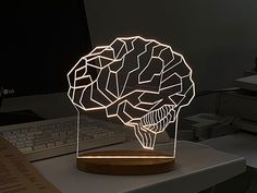 a computer desk with a light up brain on it