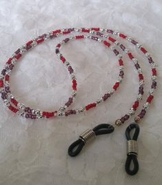 This Eye glass chain is made up of:  *Purple silver lined seed beads  *Red silver lined seed beads *Silver spacers *It's 27-1/2 inches in length approx. *-Eye glass holders are in silver finish with black rubber tip. A cute gift bag and tissue is included. All Waterfall Creations 4U are handmade by me, Janice.  :) I so enjoy creating, and I try to keep the price as low as I can depending on how many and what stones and material I use. I must charge for shipping as mailing is to costly to absorb. Silver Glass Jewelry With Colorful Beads, Silver Jewelry With Colorful Glass Beads, Silver Glass Beaded Necklace With Colorful Beads, Handmade Silver Glass Beads, Silver Beaded Necklace With Colorful Glass Beads, Silver Glass Beaded Necklaces For Party, Silver Glass Beaded Necklaces With Spacer Beads, Adjustable Silver Glasses Chains With Colorful Beads, Adjustable Glass Necklace With Silver Beads