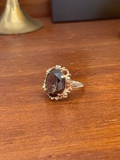 Stunning vintage 10KT gold oval smoky quartz ring. This ring is set with a stunning oval smoky quartz in an intricate setting. It is a size 7 and can be resized at your local jeweler. 5 grams. Stamped 10KT. Free shipping on US orders! Message me with any questions! Please read over all of our store policies before making your purchase. *All pre-loved jewelry is thoroughly checked and restored by a bench jeweler, so you can wear it with confidence. We do not warranty the jewelry we sell and any necessary repairs should be done at your local jeweler. *Please keep in mind that all items are vintage or antique, and they may show slight wear. We try our best to notate all issues in the description. Please look at the photos carefully to see any flaws. *We take photos in light, sunlight rooms wi Red Glitter Dress, Bench Jeweler, Smoky Quartz Ring, Gold Cocktail Ring, Silk Pocket Square, Dainty Studs, Gold Cocktail, Solid Gold Earrings, Quartz Ring