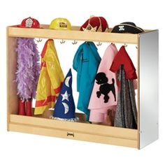 a wooden shelf filled with lots of different colored clothes and hats on top of it