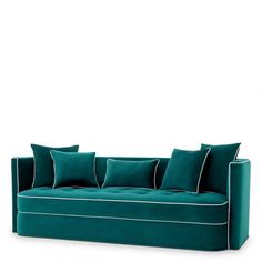 a green couch with four pillows on it