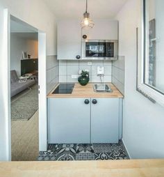 the kitchen is clean and ready for us to use in this apartment building's living room