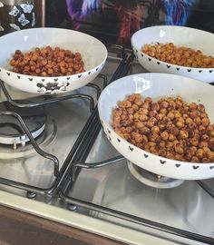 three bowls filled with food sitting on top of a stovetop oven next to each other