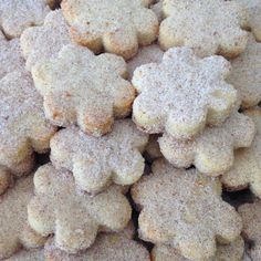 a pile of cookies with powdered sugar on top