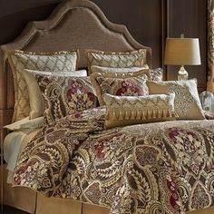 the bed is made with an intricately designed comforter and matching pillow shampoos