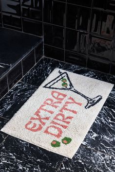 a bathroom rug with the words happy new year written in red and green on it