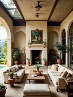 a living room filled with furniture and a fire place in the middle of a building