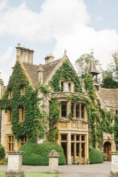 an old house with ivy growing all over it's walls and windows on the front