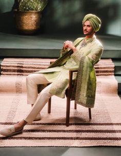 Step into refined elegance with the Pista Barfi sherwani, a soothing sage green ensemble ideal for daytime celebrations. Adorned with intricate zardozi and dabka embroidery, this sherwani features a medley of signature motifs, complemented by contrasting trousers and kurta. A perfect balance of tradition and sophistication, reminiscent of its namesake sweet. It comes with an optional dupatta. Green Nehru Jacket With Resham Embroidery For Transitional Season, Traditional Drape Kurta In Pista Green For Transitional Season, Green Raw Silk Straight Kurta Bandhgala, Green Kurta With Naqshi In Traditional Drape, Pista Green Traditional Drape Kurta For Transitional Season, Green Kurta With Naqshi And Traditional Drape, Pista Green Raw Silk Kurta For Transitional Season, Festive Pista Green Straight Kurta Bandhgala, Festive Green Raw Silk Bandhgala