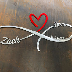 a metal sign with a heart and name on it