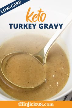 a close up of a bowl of soup with a spoon in it and the words low carb keto turkey gravy