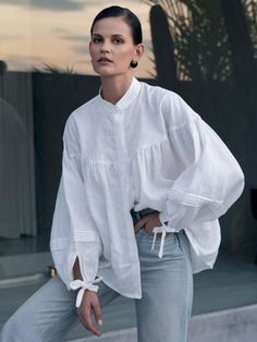 Our Oversized Blouse crafted from pure linen is all about the details. Features elegant gathers throughout, a mandarin collar and billowed sleeve that creates an air of softness. Pair with denim or our Linen Pleat Shorts 100% Linen Natural fabrication A mandarin collar Billowed sleeve with clean cuff and string closure Placket with hidden shell buttons In Natural and Black Color: Natural Material: 100% Linen Care instructions: Machine wash at max. 30ºC/86ºF with short spin cycle. Do not tumble d Oversized Tops For Women, Casual Linen Blouse With Balloon Sleeves, Spring Linen Lantern Sleeve Tops, Spring Stand Collar Blouse For Daywear, Stand Collar Blouse For Spring Daywear, Stand Collar Blouse For Daywear In Spring, Relaxed Fit Ramie Blouse For Daywear, Spring Linen Blouse With Balloon Sleeves, Linen Tops With Gathered Sleeves For Daywear