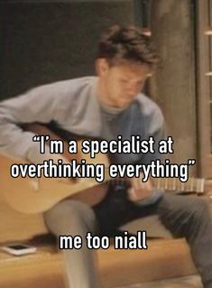 a man sitting on top of a wooden bench holding an acoustic guitar with the caption i'm a specialist at overthiling everything me too