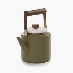 a green tea kettle with a wooden handle