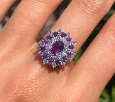 A beautiful 9ct gold cluster ring set with colourful amethyst stones and some sort of semi precious white stone (possibly cubic zirconia). The ring is fully hallmarked on the inside band with the date letter for 1987. Size Q 1/2 All orders placed will be wrapped in bubble wrap and tissue paper and posted in a cardboard large letter box. Purple Multi-stone Amethyst Ring In Fine Jewelry Style, Fine Jewelry Purple Amethyst Multi-stone Ring, Purple Multi-stone Amethyst Ring Fine Jewelry, Purple Multi-stone Amethyst Ring, Multi-stone Cluster Ring In Cubic Zirconia, Purple Sapphire Multi-stone Ring With Diamonds, Fine Jewelry Purple Cluster Ring For Anniversary, Purple Cluster Ring For Anniversary In Fine Jewelry, Fine Jewelry Purple Cluster Rings