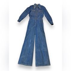 Make A Statement With This 1970s Rafael Denim Bell Bottom Jumpsuit. Embrace Your Inner Hippie And Channel Your Unique Style With This Chic Piece. Perfect For Any Occasion! Era: 1970s Style: Jumpsuit Tag Size: Undetermined Color: Denim Rating: 8 10; Flawed Please Pictures Content: Denim Measurements: Bust: 36” Drop: 8.5” Waist: 25” Inseam: 30.5” Length: 68” Shoulder: 13” Inner Sleeve: 16” Outer Sleeve: 28@ Cleaning + Care: Bell Bottom Jumpsuits, 1970s Style, Style Jumpsuit, 1970s Fashion, Bell Bottom, Bell Bottoms, Pant Jumpsuit, Jumpsuit Romper, Unique Style