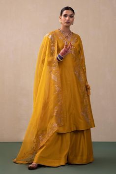 Mustard angrakha featuring embroidered zari mor motifs highlighted with sequin work. Comes with plain sharara and dupatta.
Components: 3
Pattern: Hand Embroidery
Type Of Work: Zari, Mor
Neckline: V Neck
Sleeve Type: Three Quarter Sleeves
Fabric: Silk Chanderi, Dupatta: Organza
Color: Yellow
Other Details: 
Overlap kurta panels with drawcord closure
Occasion: Sangeet - Aza Fashions Plain Sharara, Peacock Motifs, Kurta Sharara Set, Chanderi Dupatta, Kurta Sharara, Traditional Attires, Pink City, Yellow Silk, Sharara Set