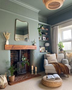 a living room filled with furniture and a fire place in front of a mirror on the wall