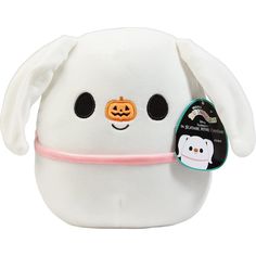 a white stuffed animal with a pink ribbon around it's neck and eyes that have pumpkins on them