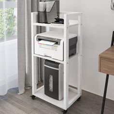 a computer desk with a printer on top of it