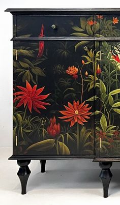 a black cabinet with flowers painted on it