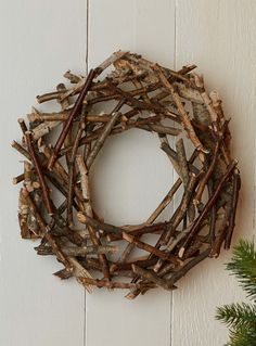 a twig wreath hanging on the wall