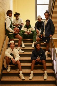 a group of young men sitting on top of stairs