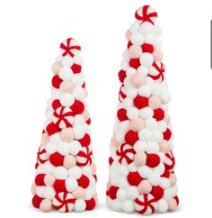 two red and white christmas trees made out of pom - poms are shown